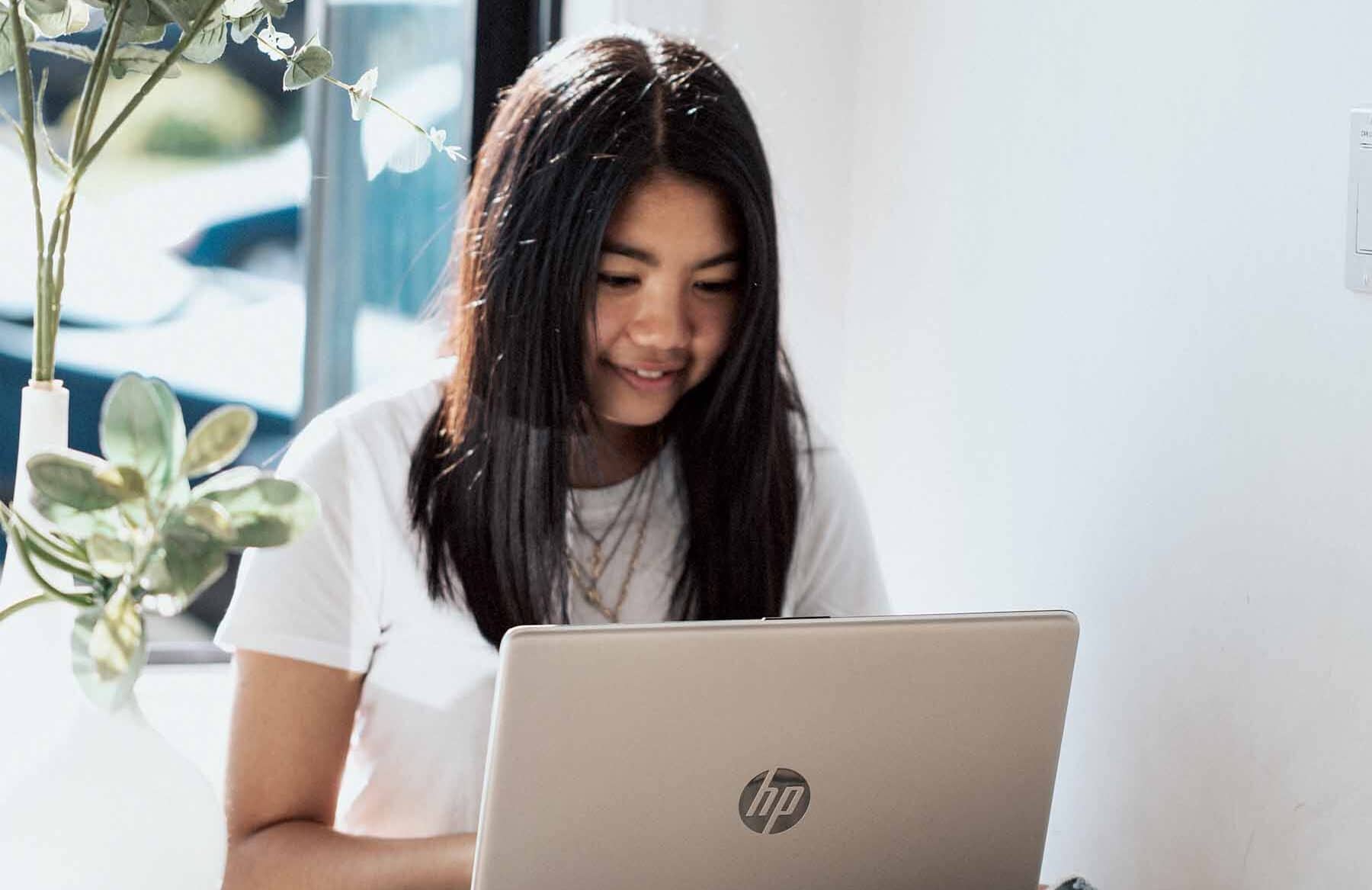 young-girl-looking-at-laptop-near-window - Metro Continuing Education